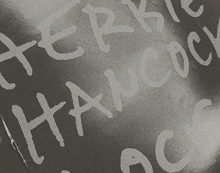 CLOSE-UP VIEW OF TEXT ON WALL