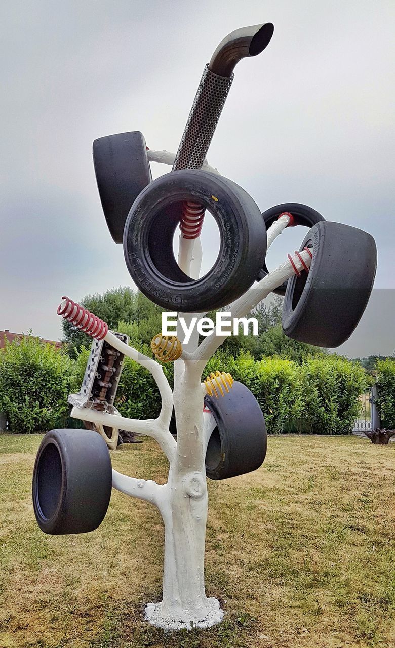 COIN-OPERATED BINOCULARS ON FIELD AGAINST SKY