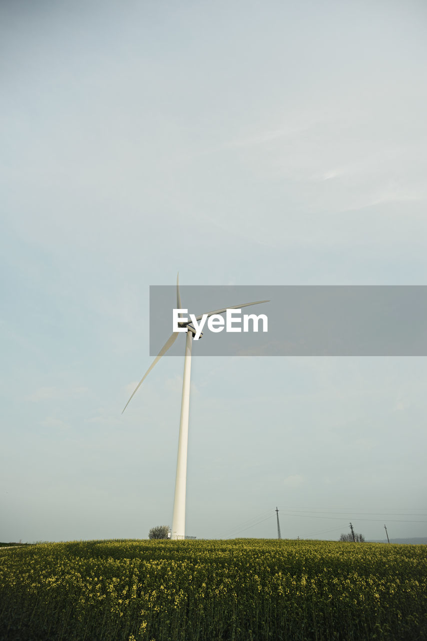 Windmill on field against sky