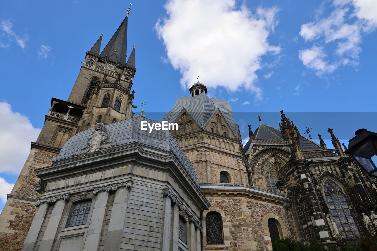 Low angle view of cathedral in aachen against sky