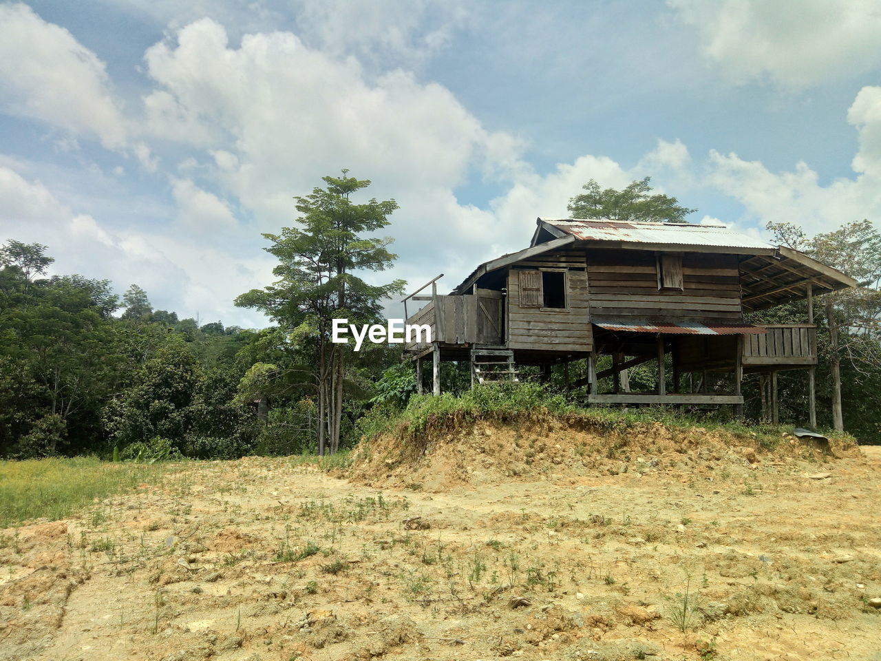 Abandoned house on field against sky