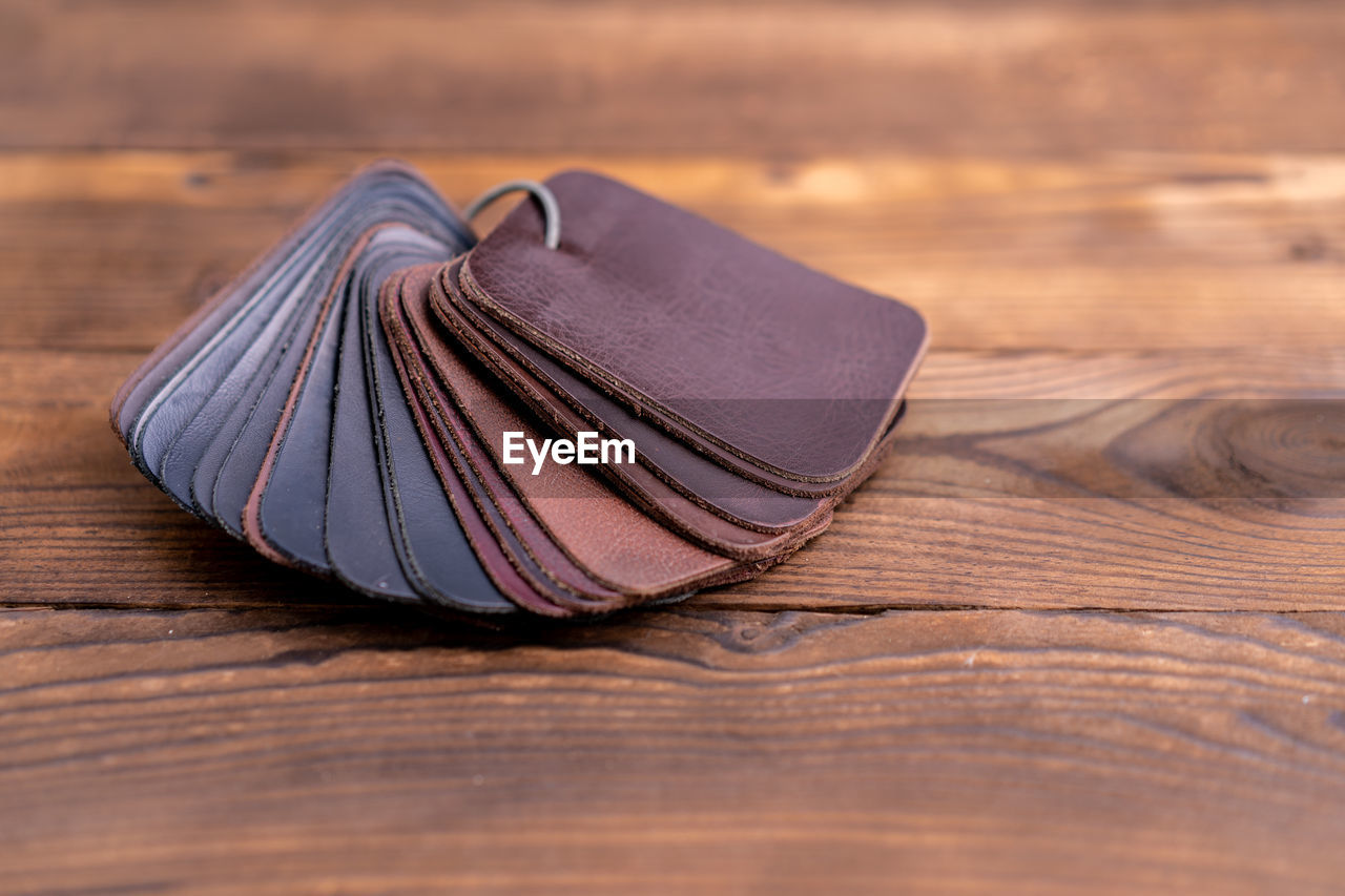 HIGH ANGLE VIEW OF SHOES ON WOODEN TABLE