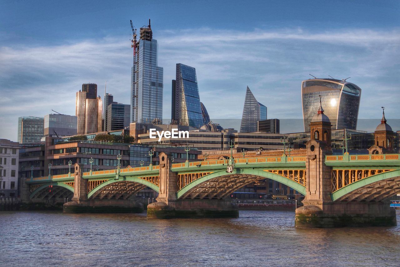 Bridge over river with buildings in background