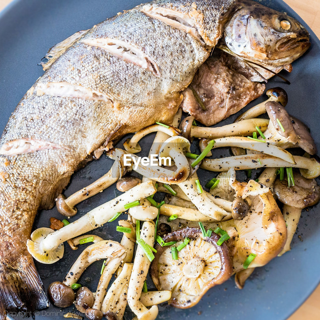 High angle view of cooked fish and vegetables in plate