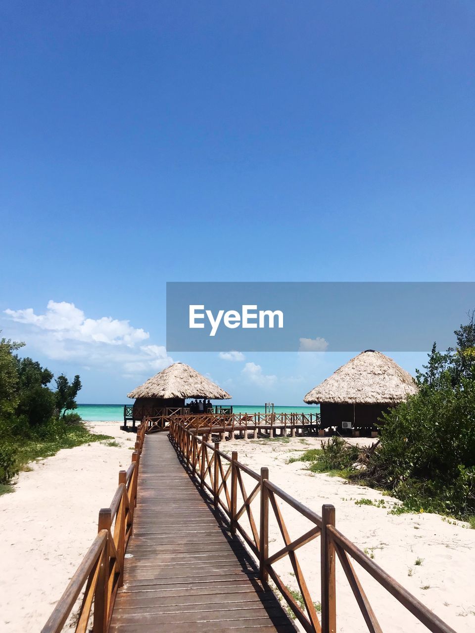 FOOTBRIDGE OVER BEACH AGAINST SKY