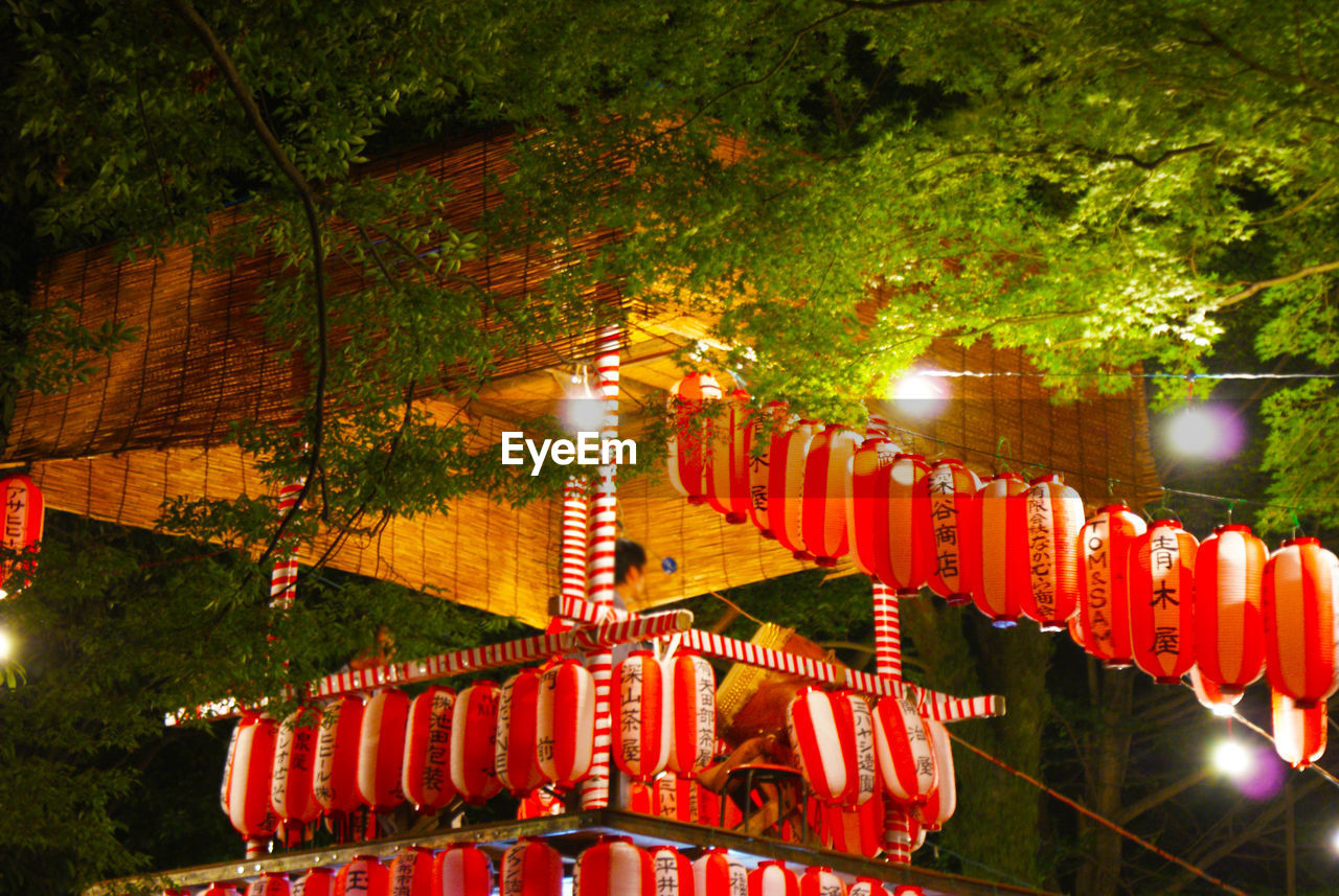 lighting equipment, illuminated, lantern, night, hanging, chinese lantern, tree, decoration, celebration, chinese lantern festival, plant, chinese new year, event, no people, tradition, festival, nature, architecture, red, traditional festival, outdoors, built structure, holiday, light, christmas lights, text