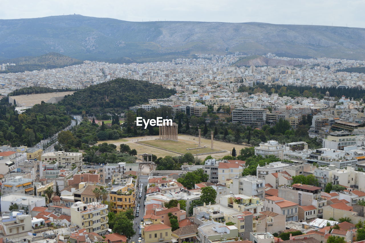 Aerial view of cityscape against mountains