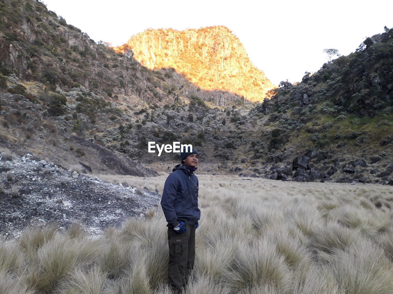 Full length of man standing on mountain against sky