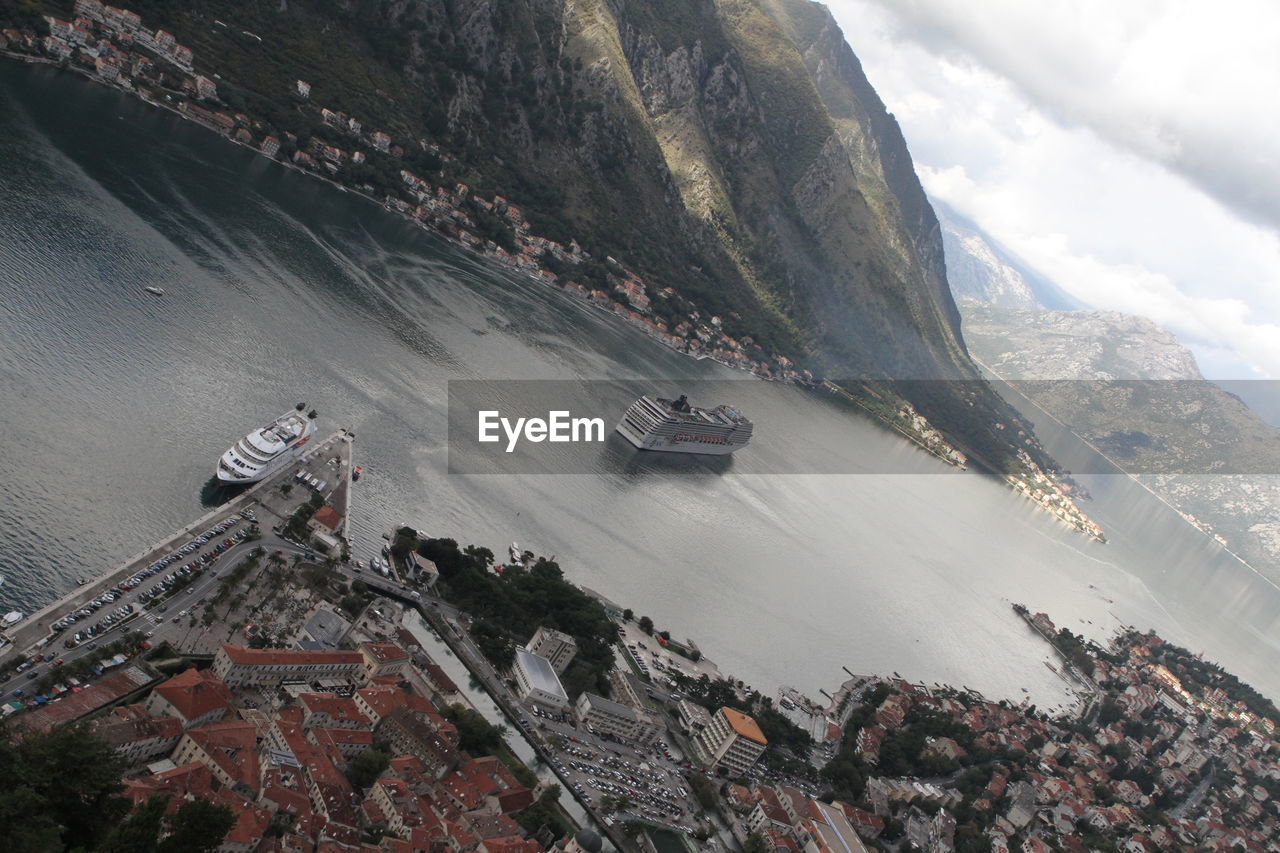 High angle view of sea by mountain against sky