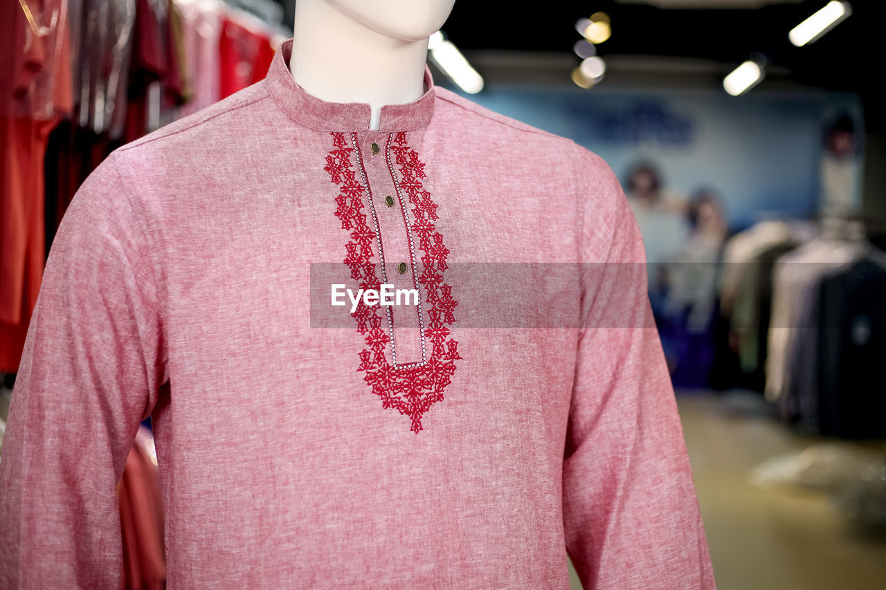 Close-up of pink kurta on mannequin in store