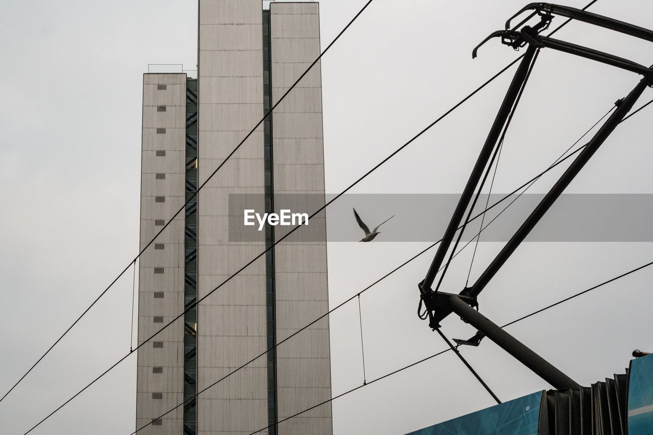 Low angle view of electricity pylon against clear sky