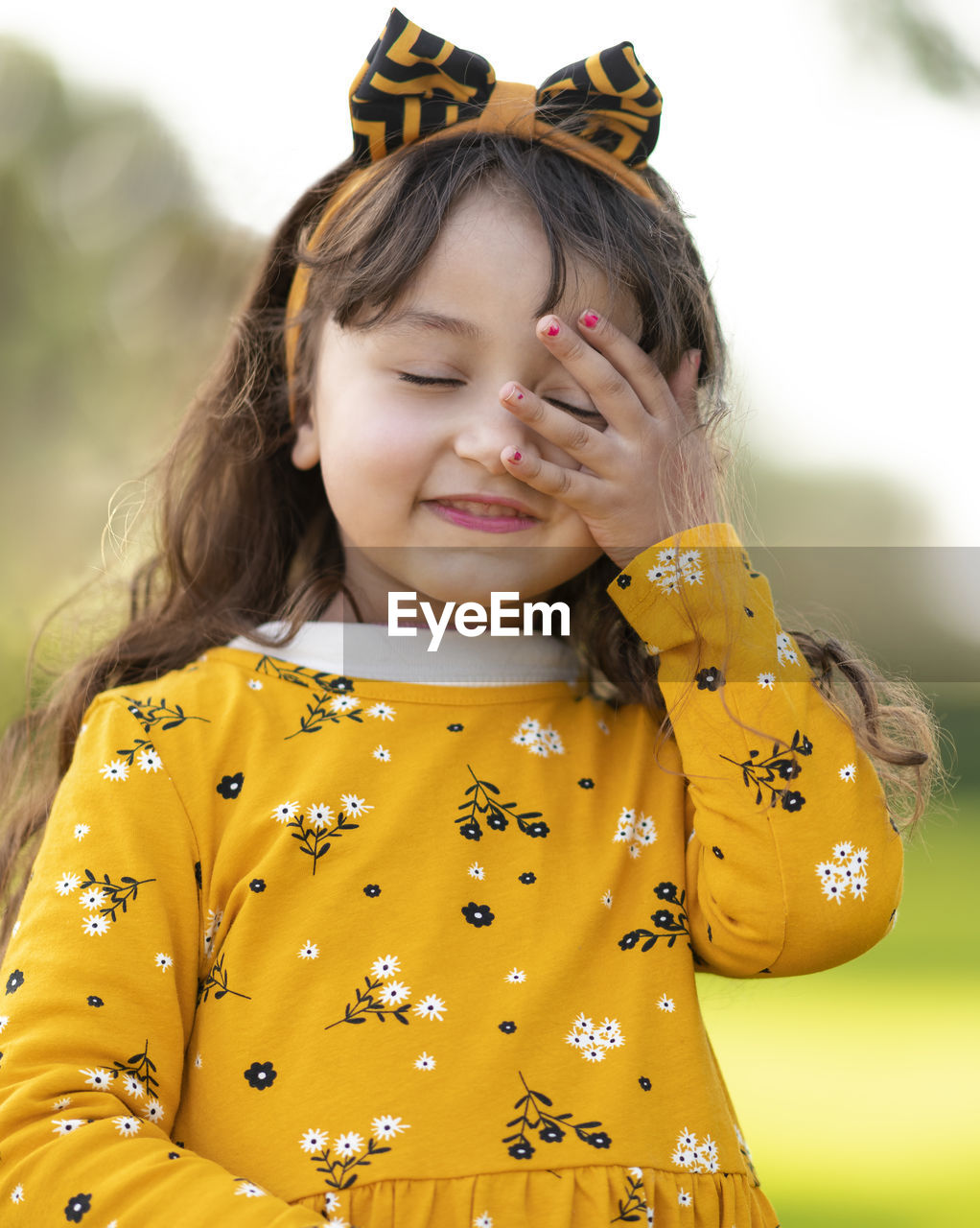 CLOSE-UP PORTRAIT OF CUTE GIRL WITH YELLOW HAT