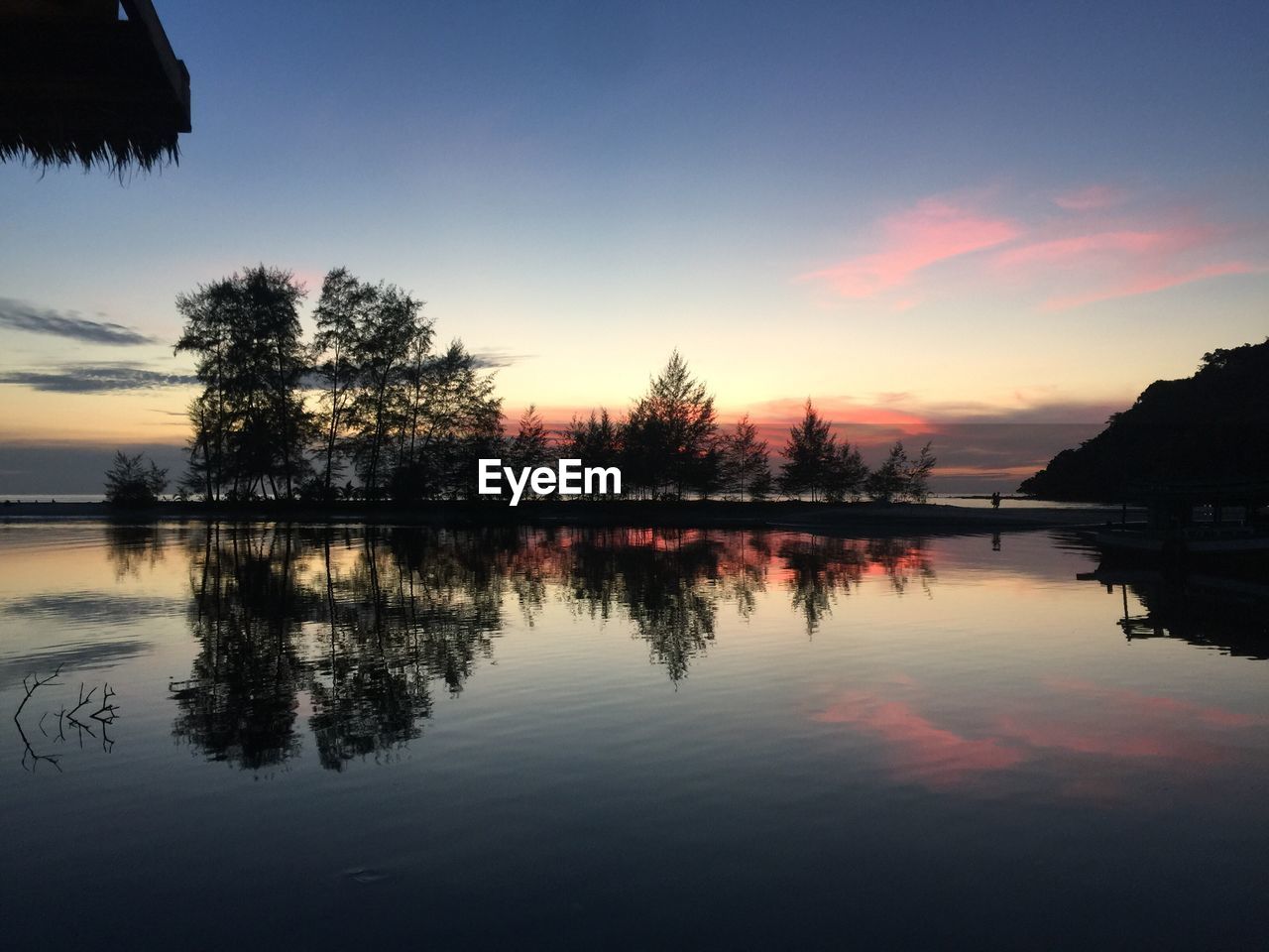 Scenic view of lake against sky during sunset