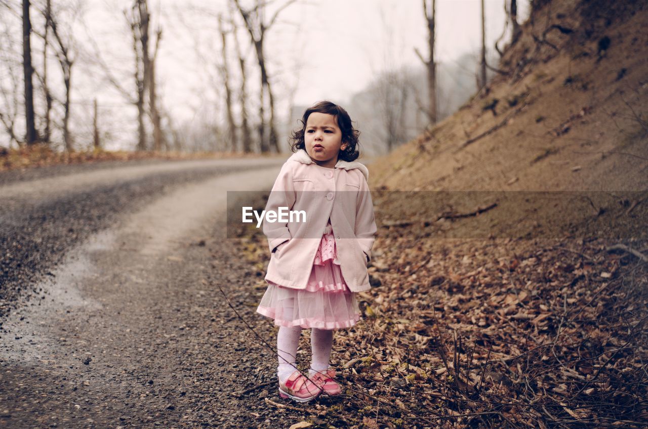 Full length of girl standing at roadside