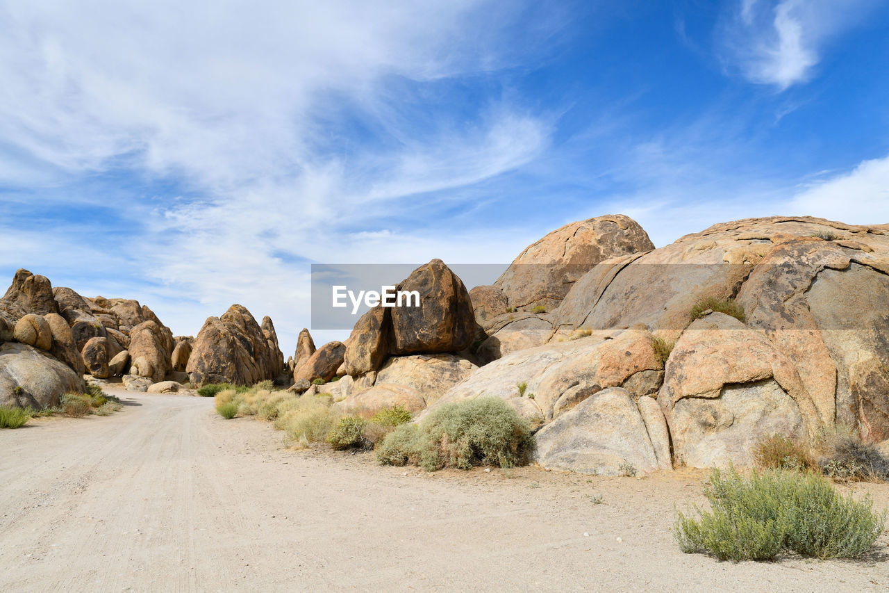 Panoramic view of road amidst rocks against sky