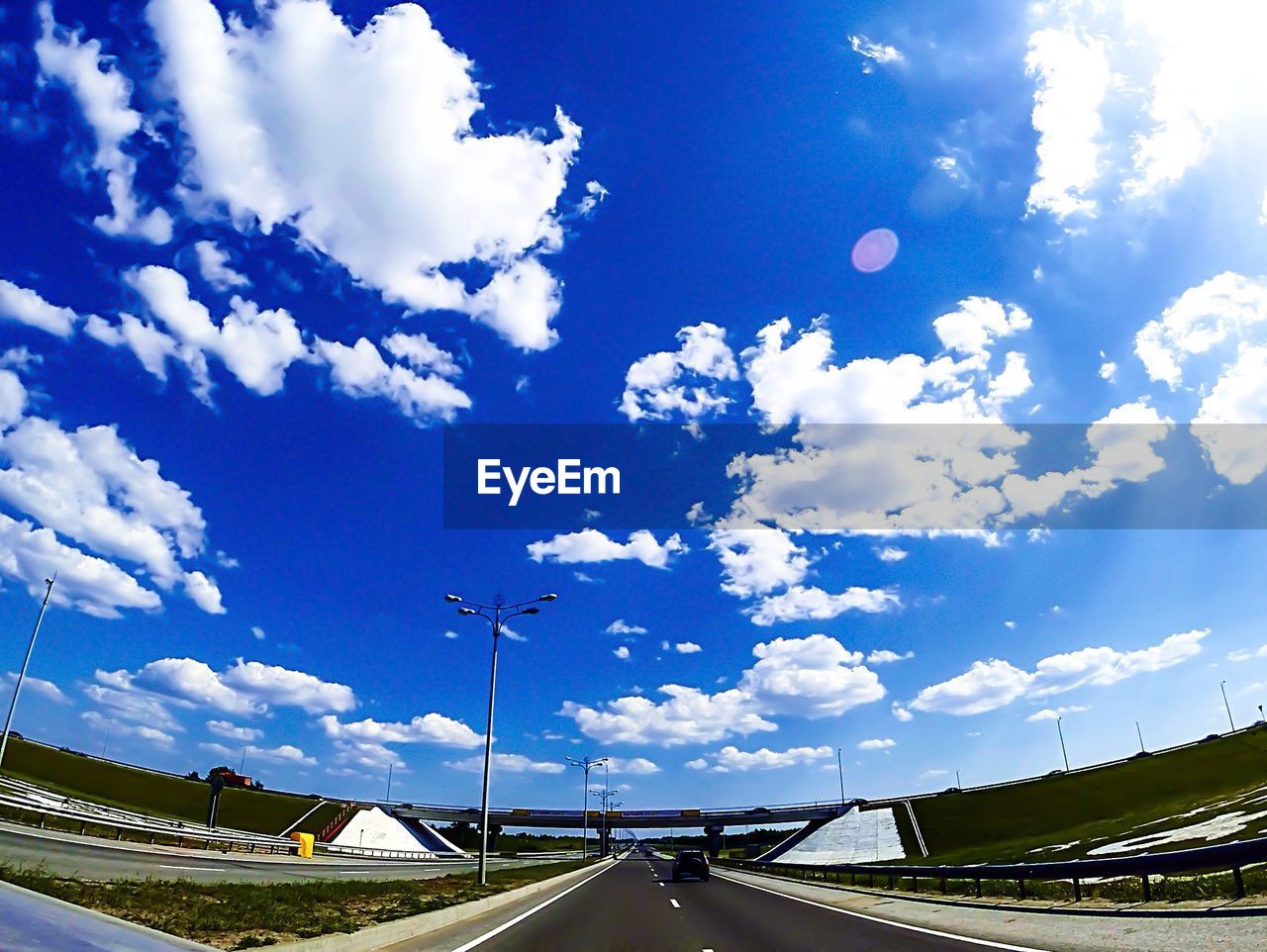 EMPTY ROAD AGAINST CLOUDY SKY