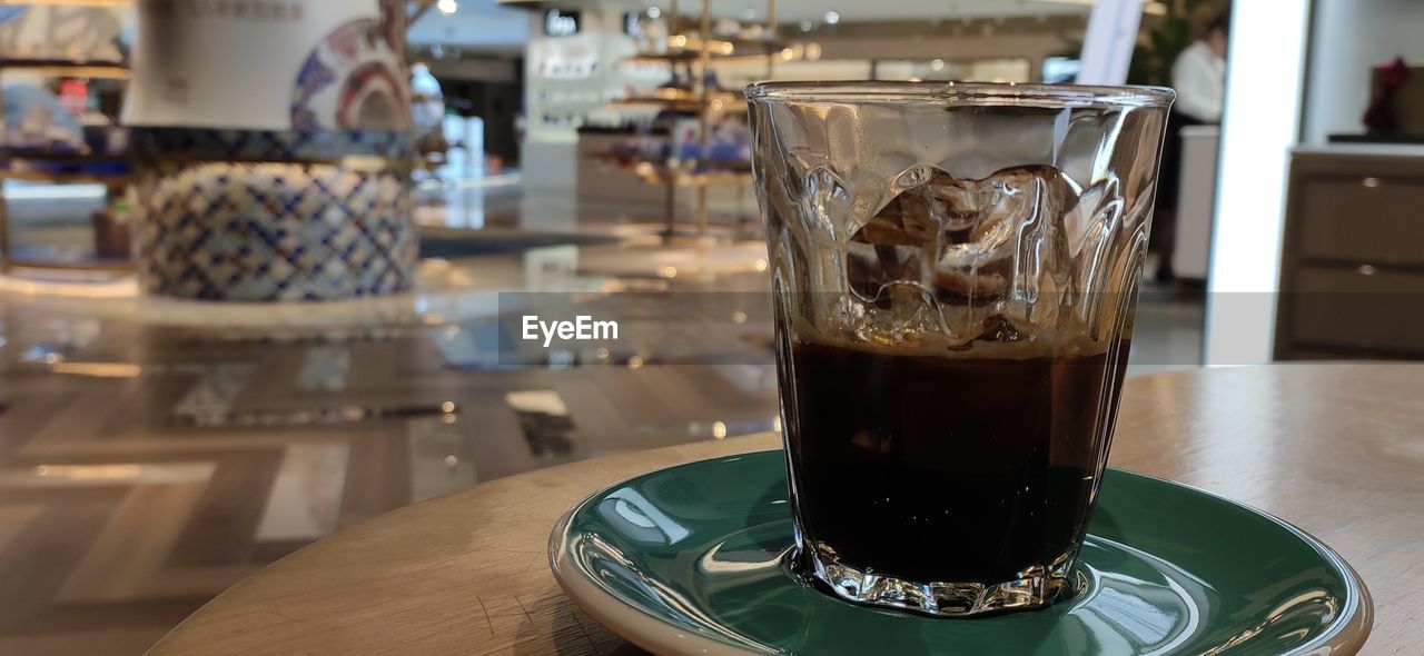 CLOSE-UP OF COFFEE ON TABLE