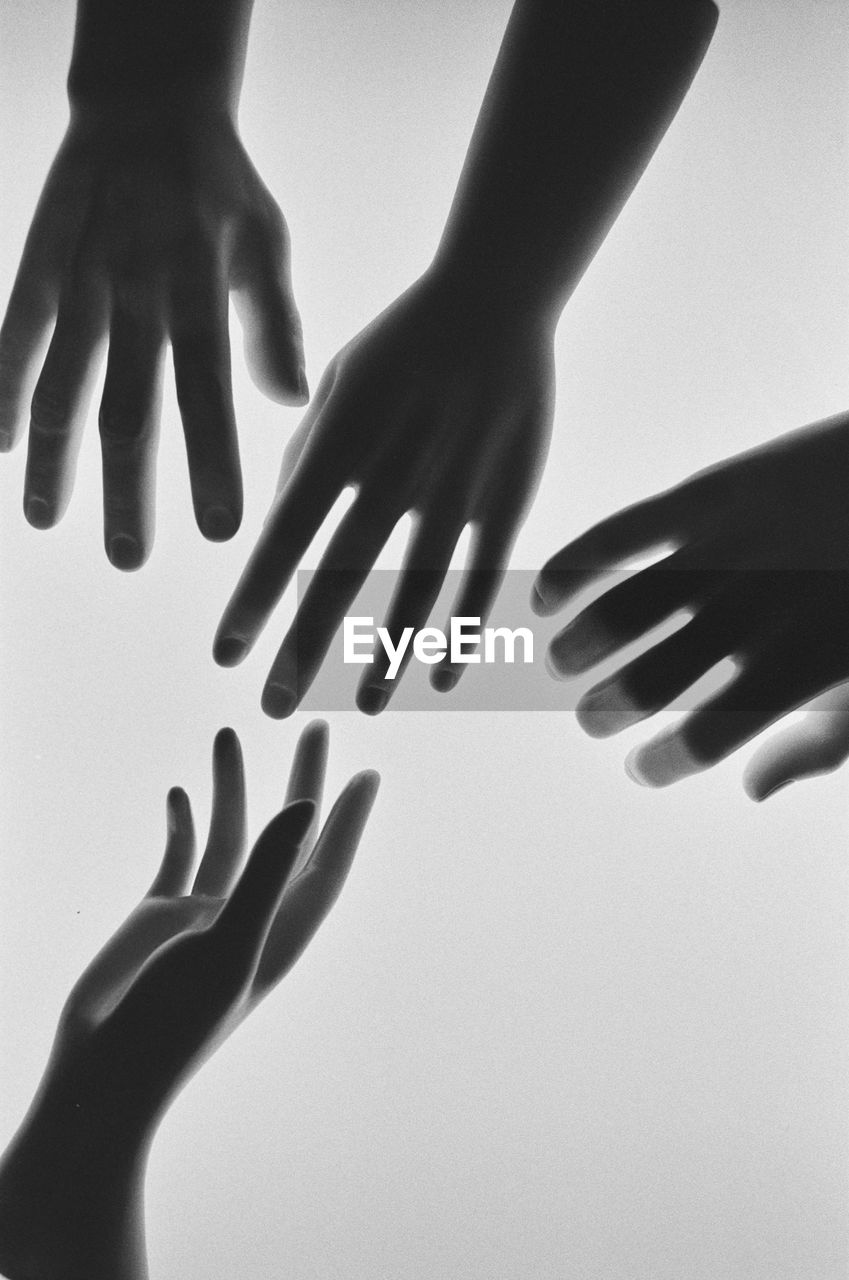 Close-up of hands over white background