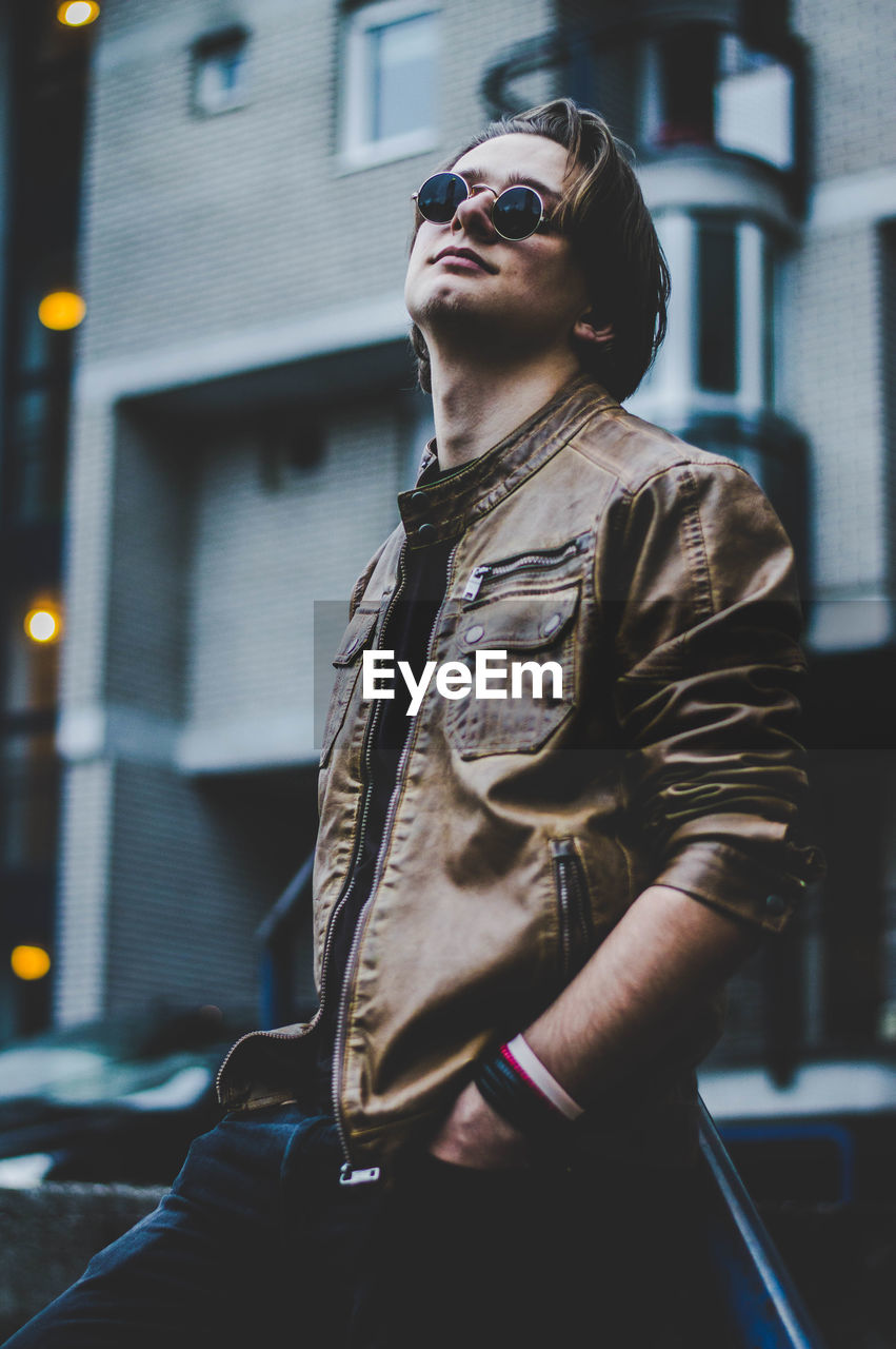 Close-up of man wearing sunglasses standing in city