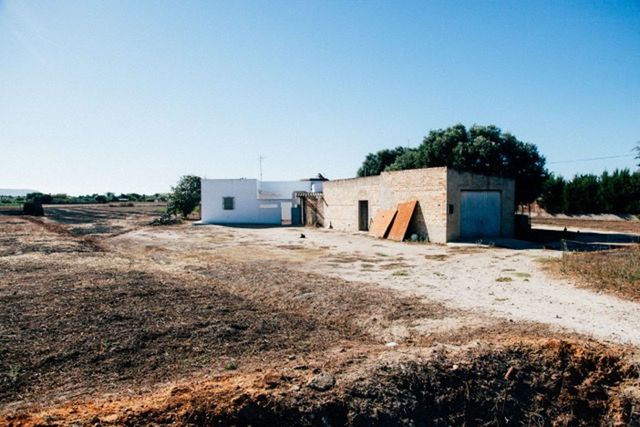 BUILT STRUCTURE ON LANDSCAPE AGAINST CLEAR SKY