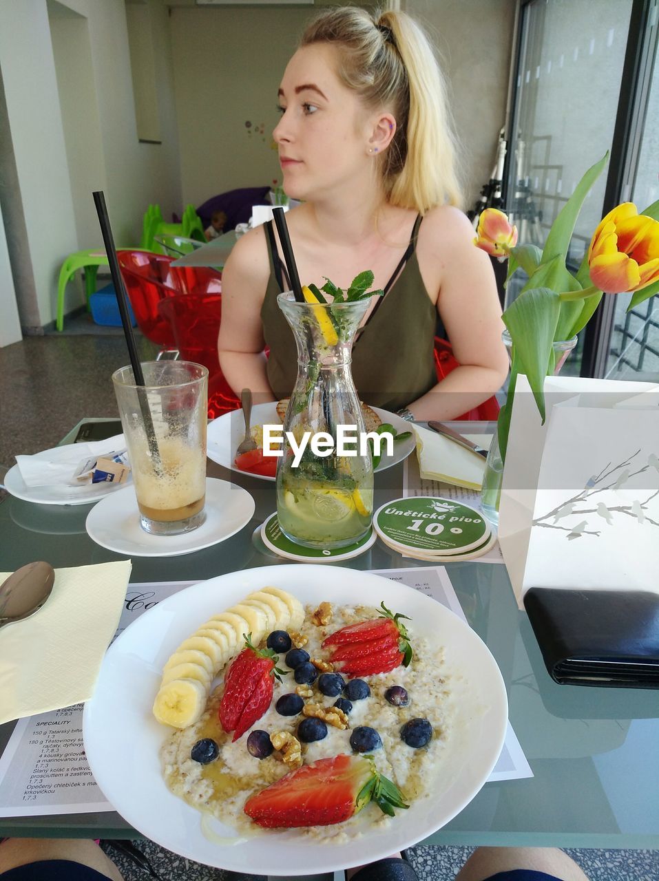 Young woman with breakfast on table