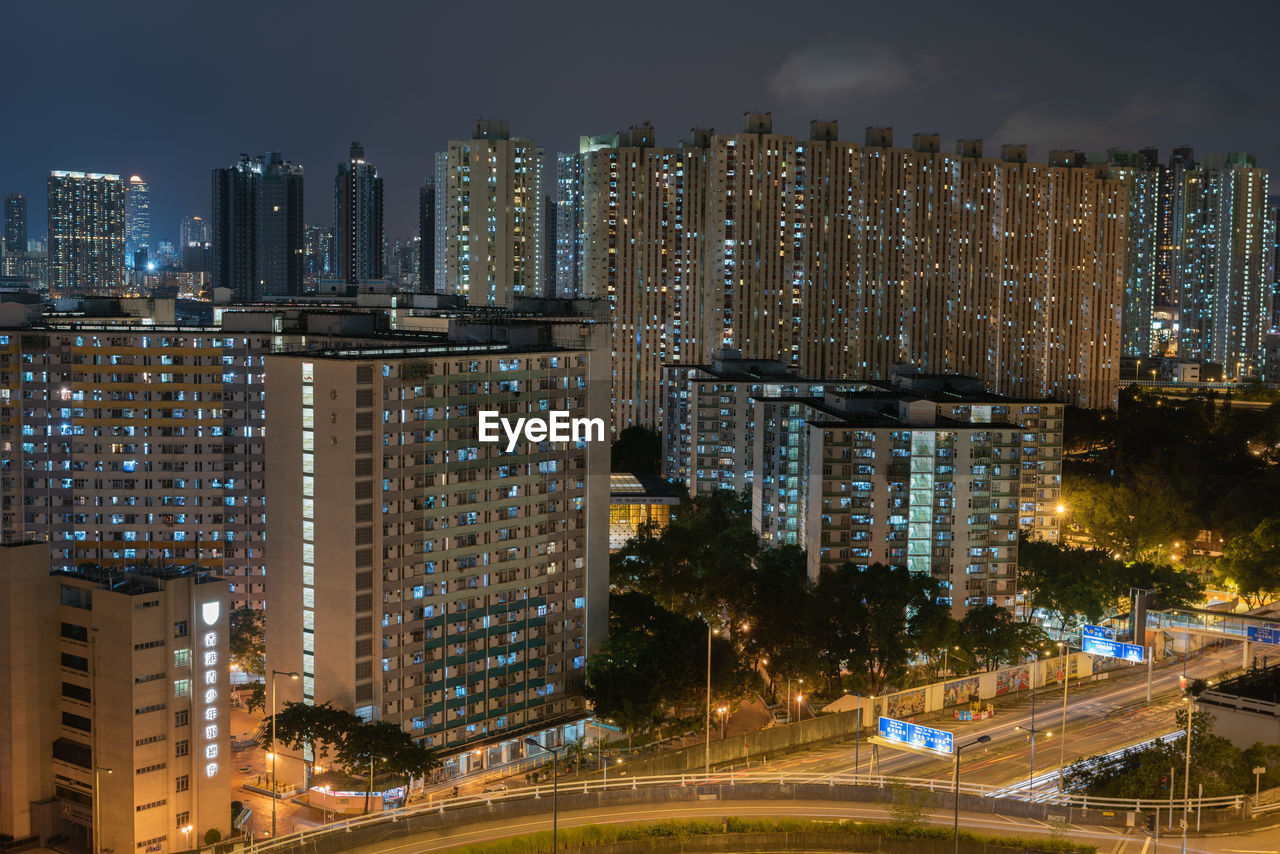 ILLUMINATED BUILDINGS AGAINST SKY AT NIGHT
