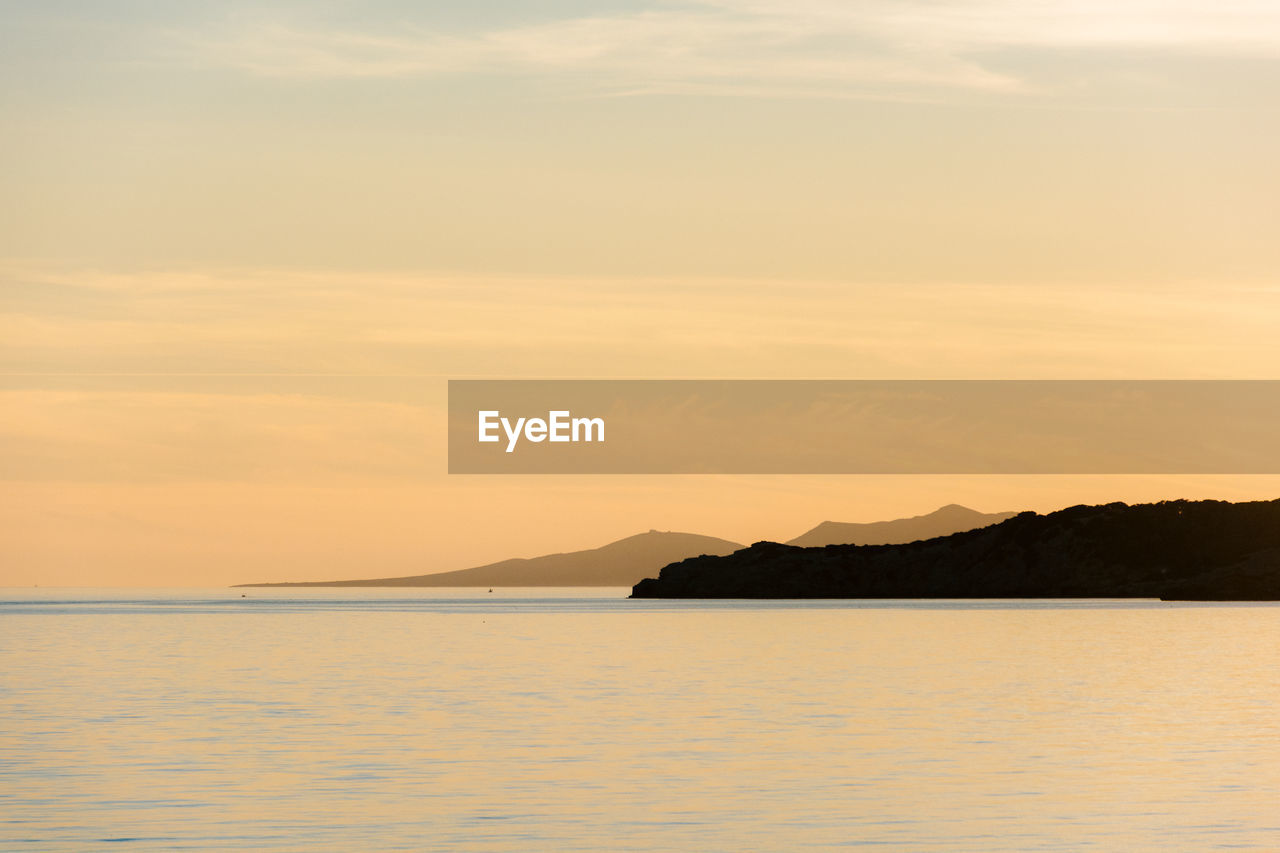 Scenic view of sea against sky at sunset