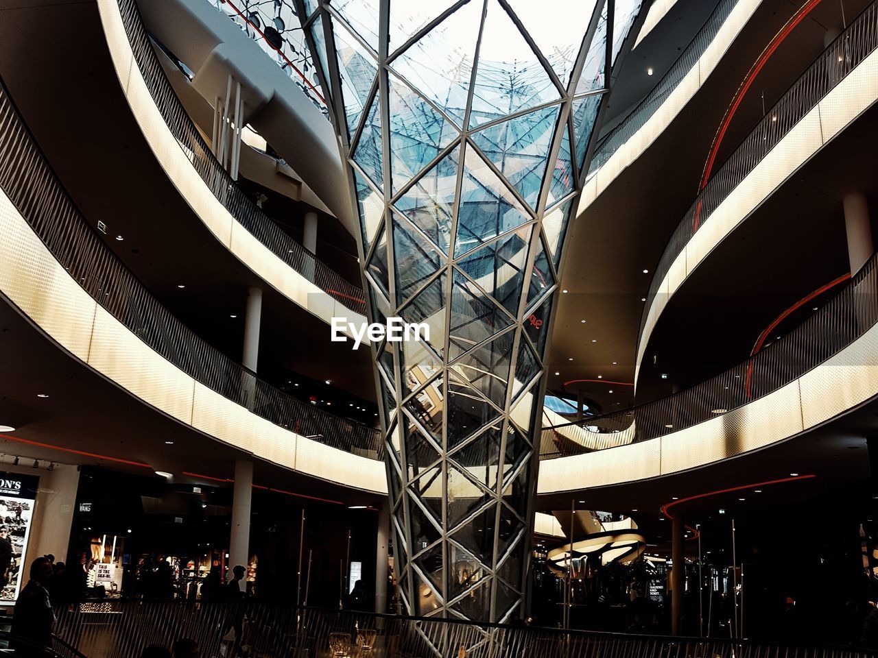 LOW ANGLE VIEW OF ILLUMINATED SHOPPING MALL IN CITY