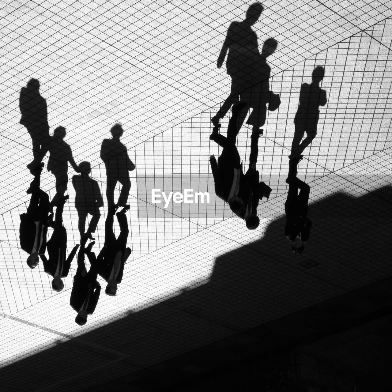 HIGH ANGLE VIEW OF PEOPLE WALKING ON ZEBRA CROSSING