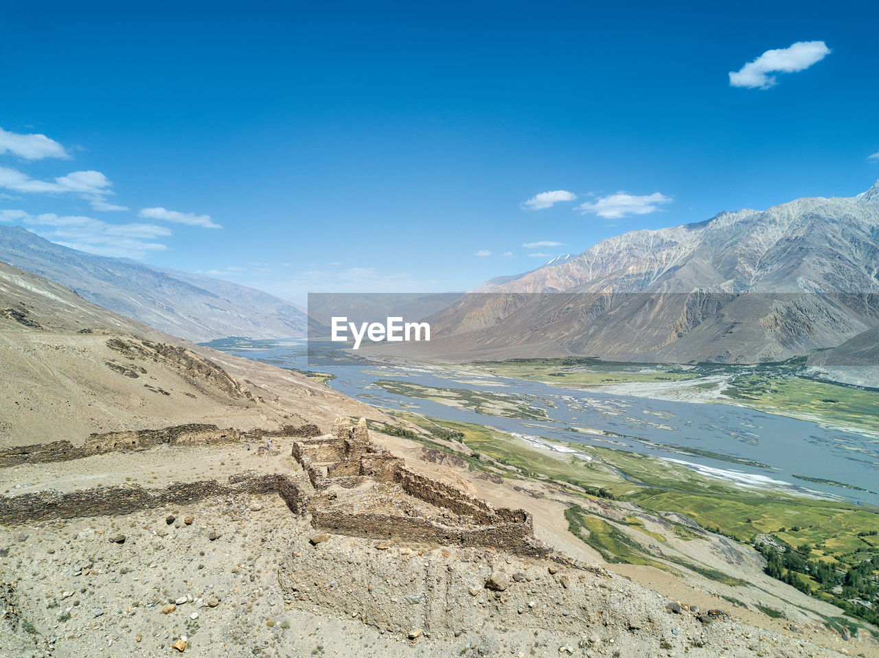 Scenic view of mountains against blue sky