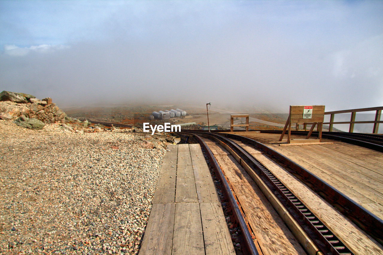 Train on railroad tracks against sky