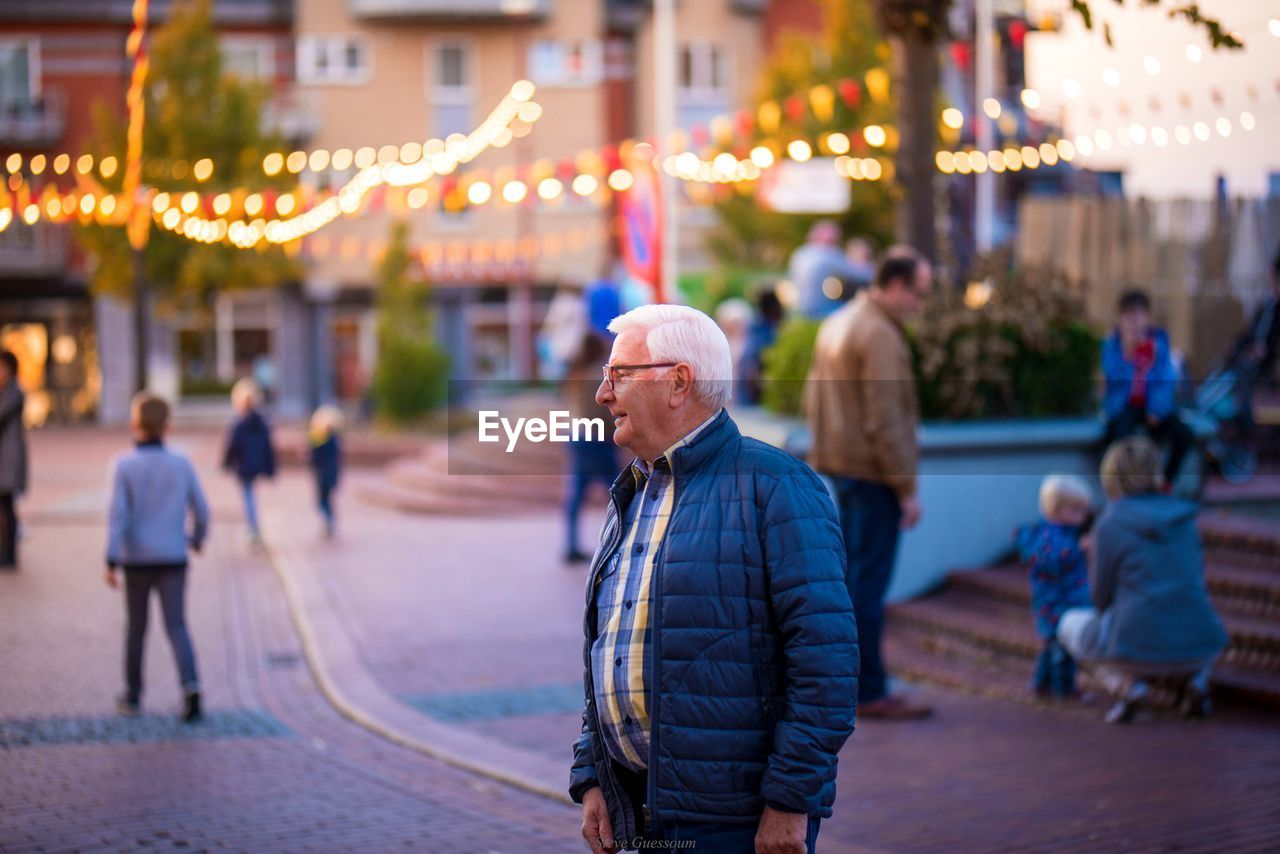 Man standing on road in city