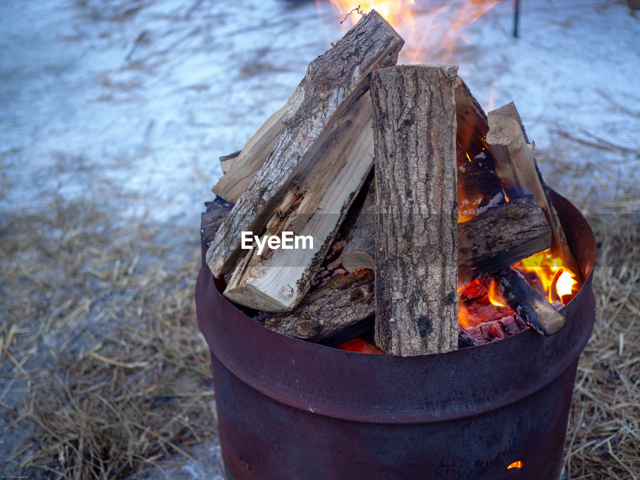Close-up of fire on wood in burn barrels.