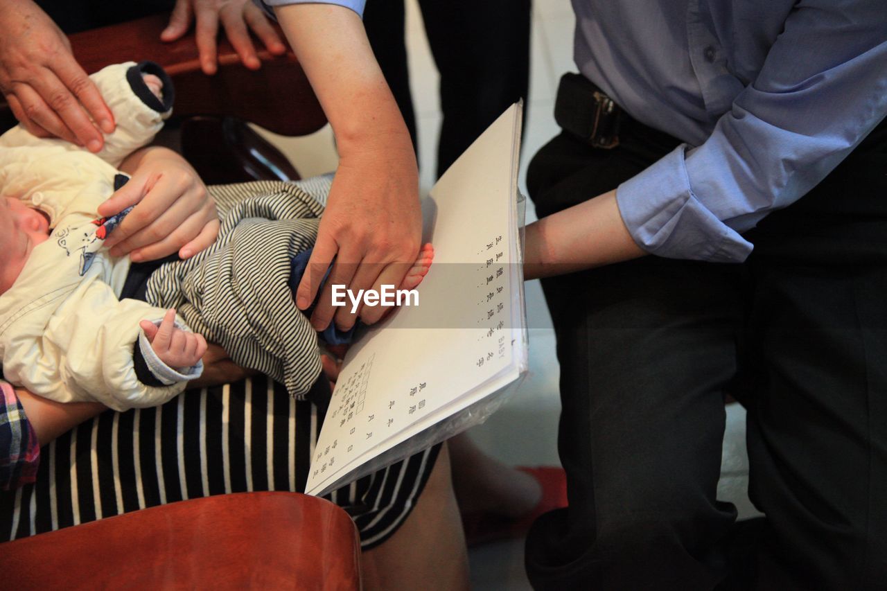 Man taking footprint of baby on paper