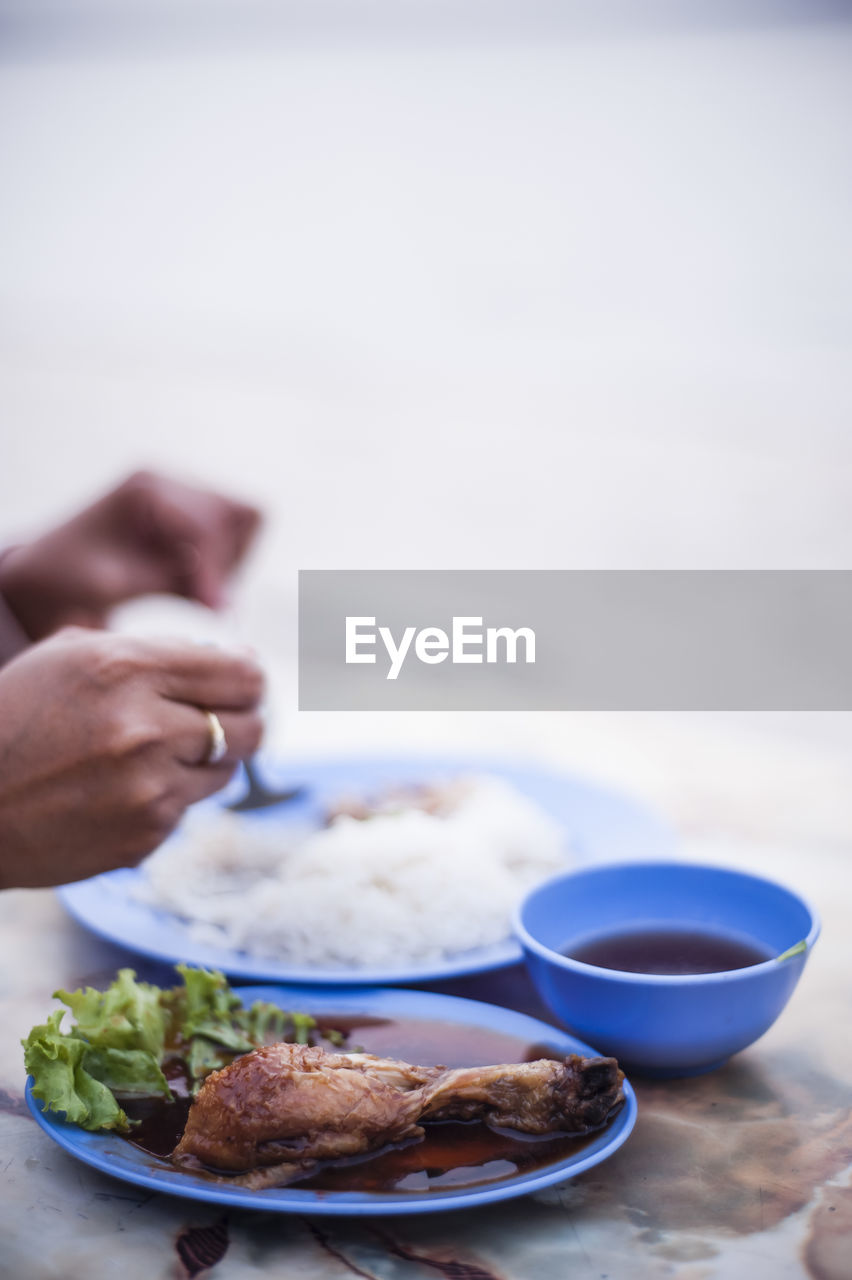 Cropped image of person having food