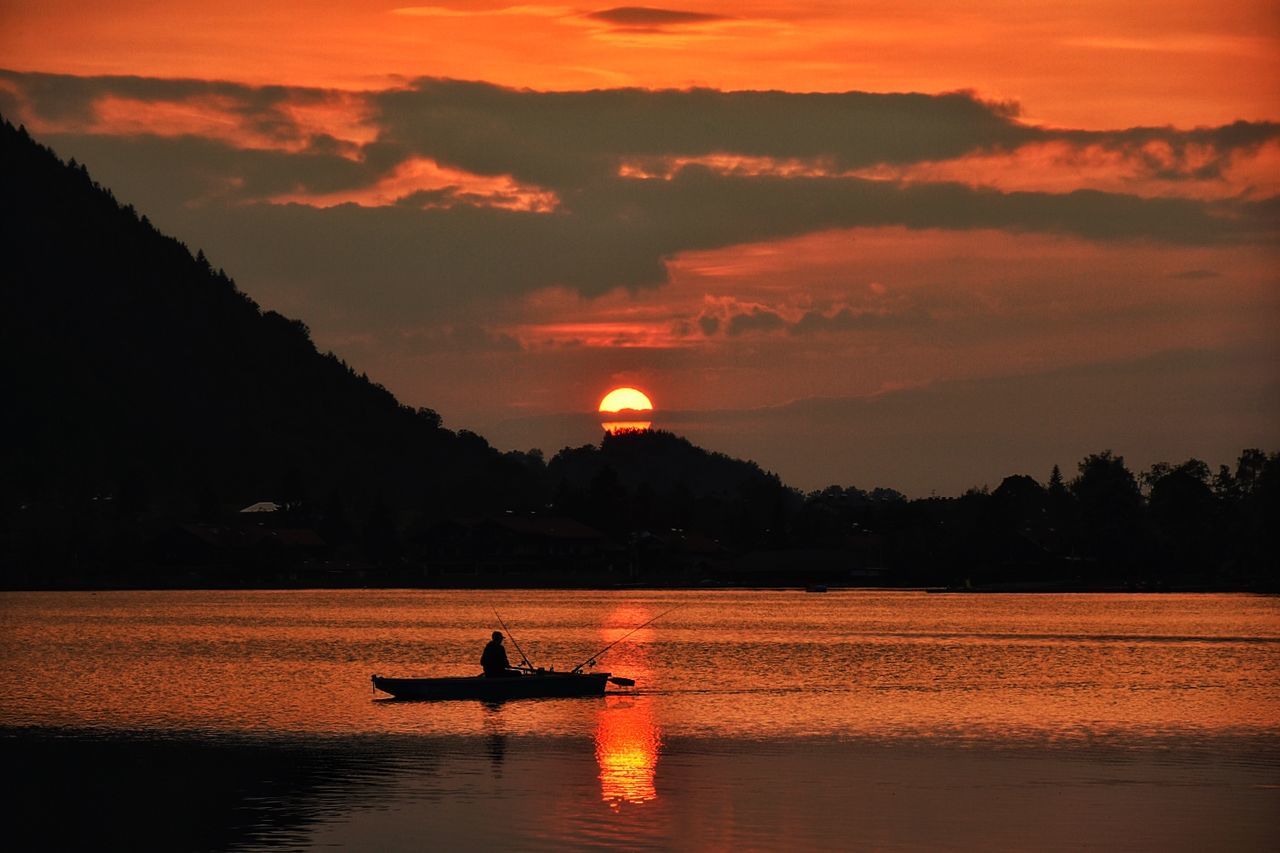 SILHOUETTE BOAT IN SEA AGAINST ORANGE SKY