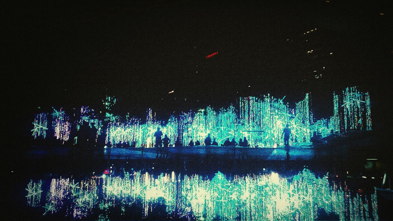 REFLECTION OF ILLUMINATED LIGHTS ON WATER