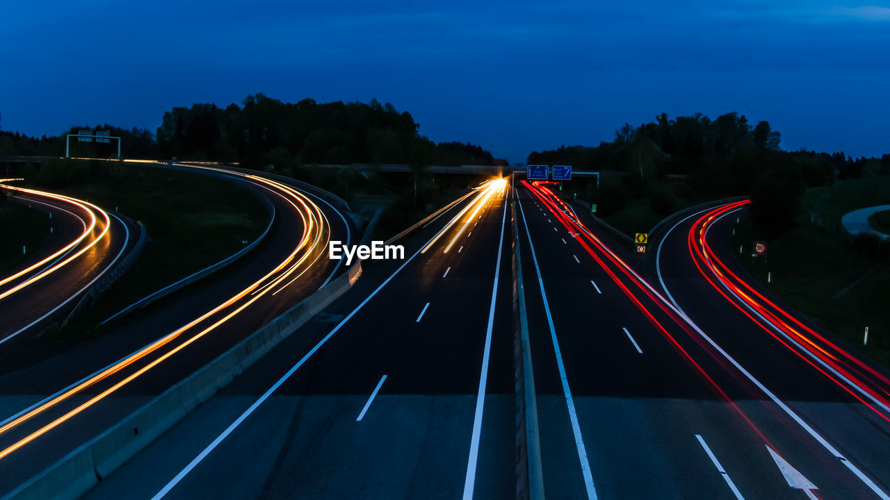 High angle view of light trails on highway at night