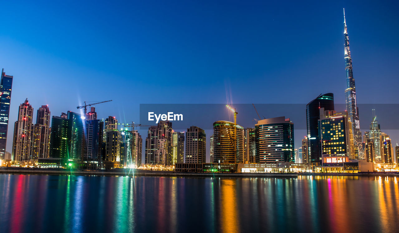 Low angle view of skyscrapers lit up at night