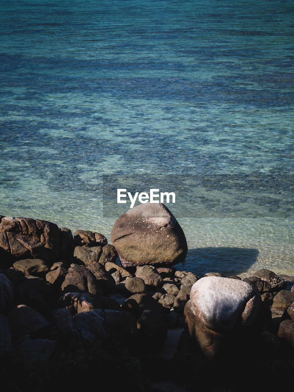 water, rock, sea, ocean, nature, beach, beauty in nature, coast, land, shore, reflection, tranquility, day, scenics - nature, no people, tranquil scene, blue, horizon, high angle view, sunlight, outdoors, idyllic