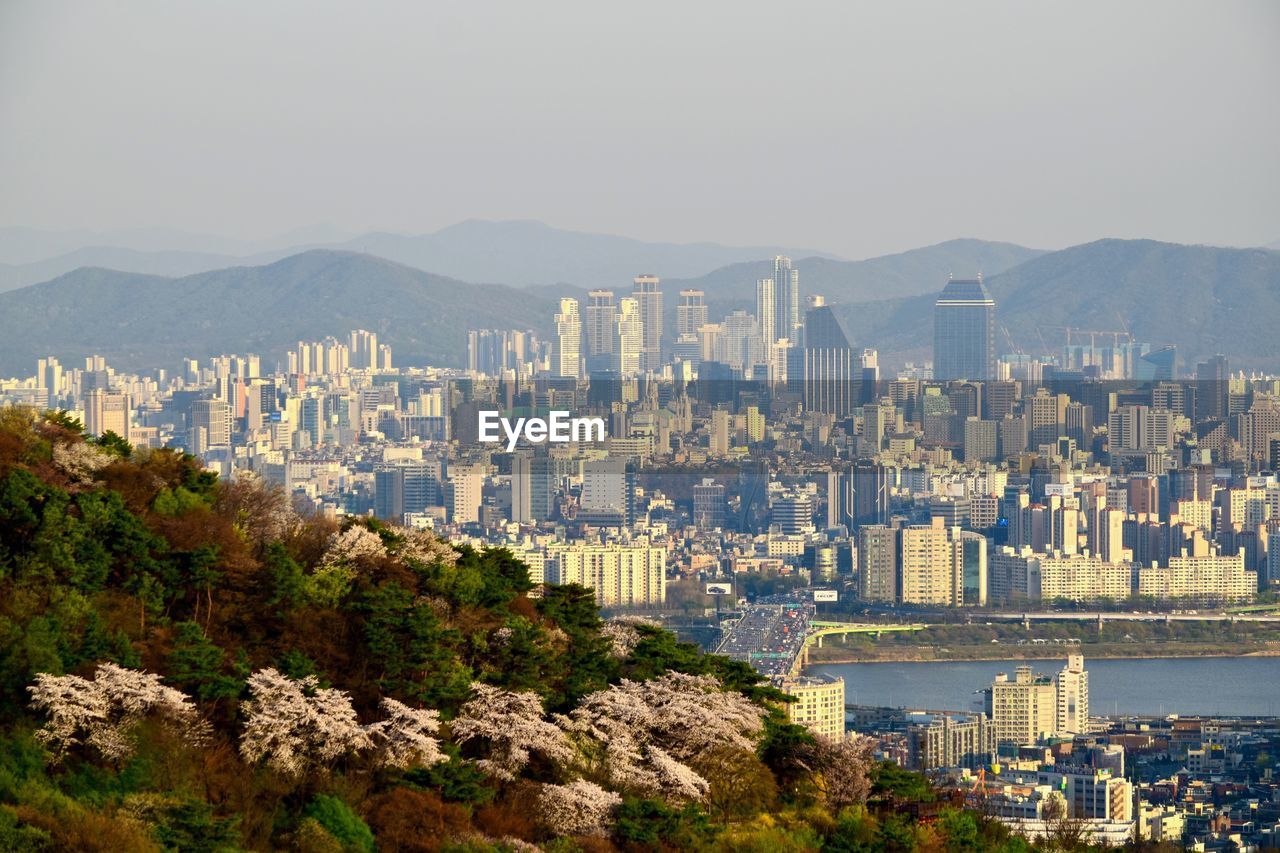 Aerial view of city and buildings against clear sky