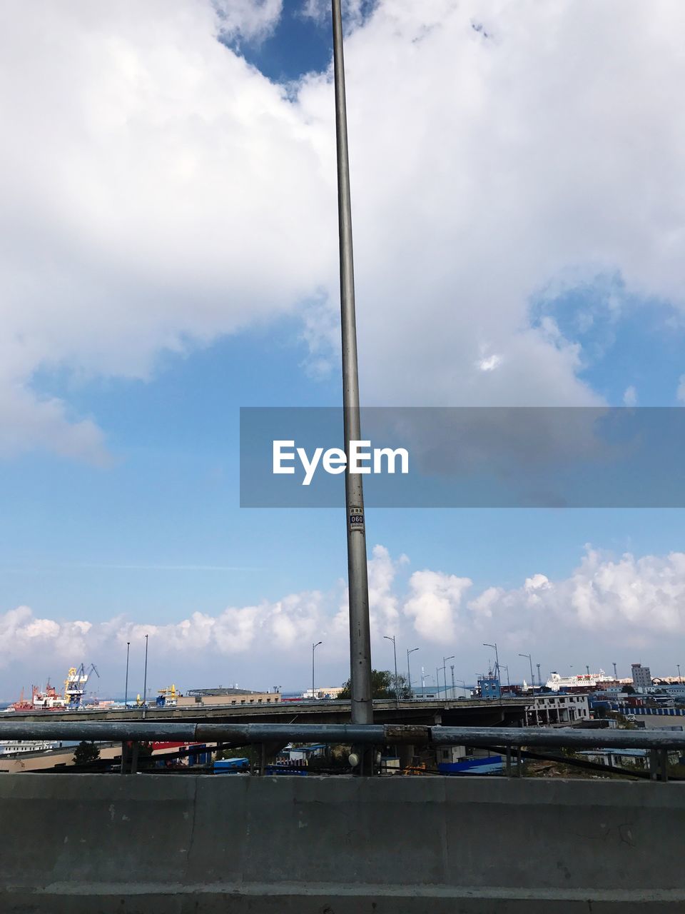 SUSPENSION BRIDGE AGAINST CLOUDY SKY