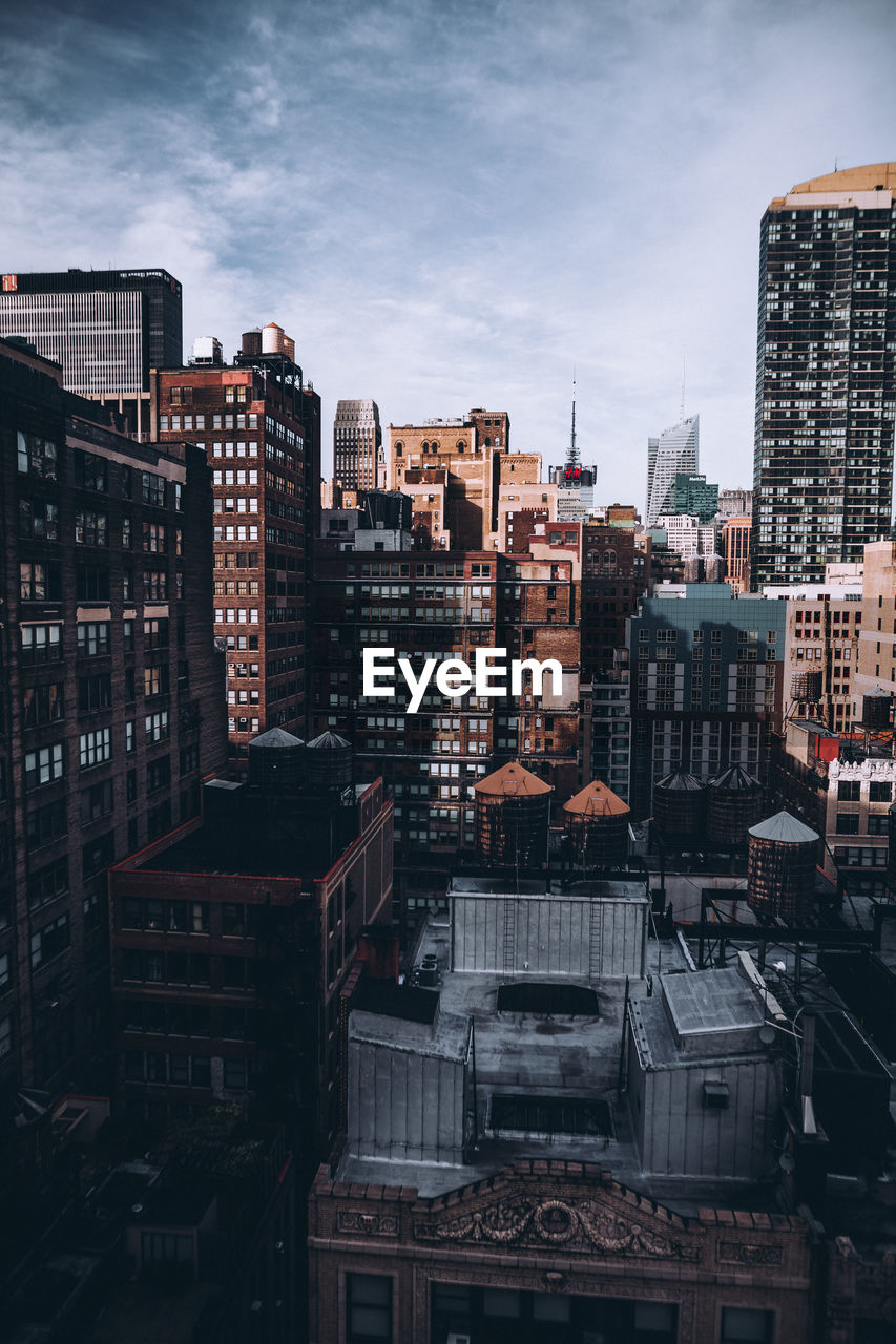 Cityscape against cloudy sky