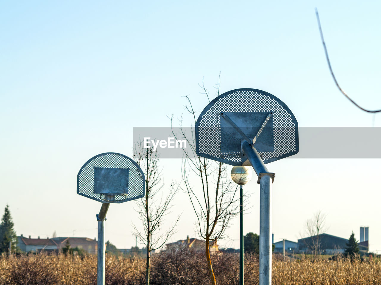 LOW ANGLE VIEW OF BASKETBALL HOOP AGAINST SKY