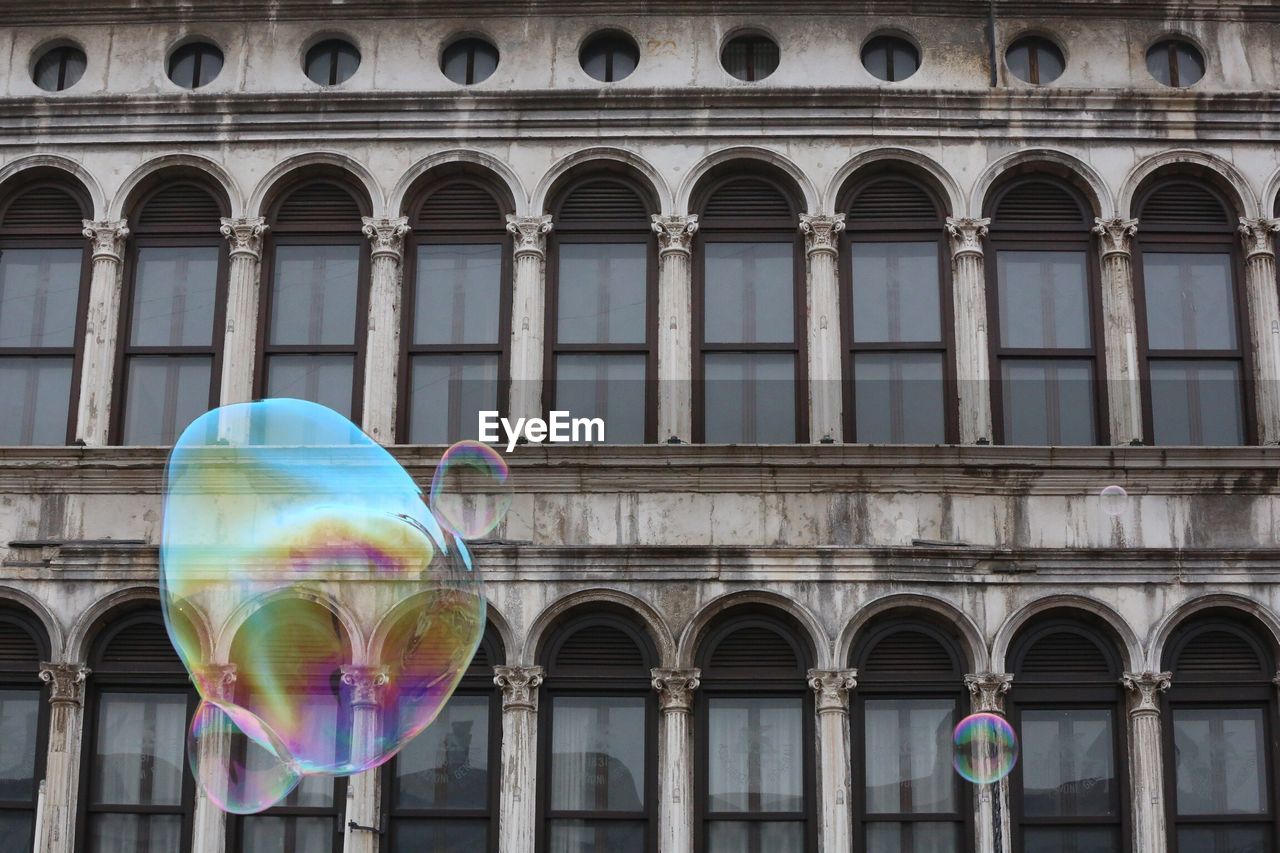 Soap bubbles with building in background