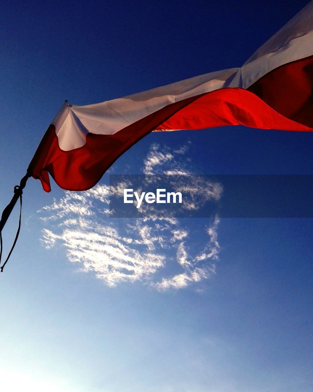 LOW ANGLE VIEW OF FLAGS FLAG AGAINST BLUE SKY