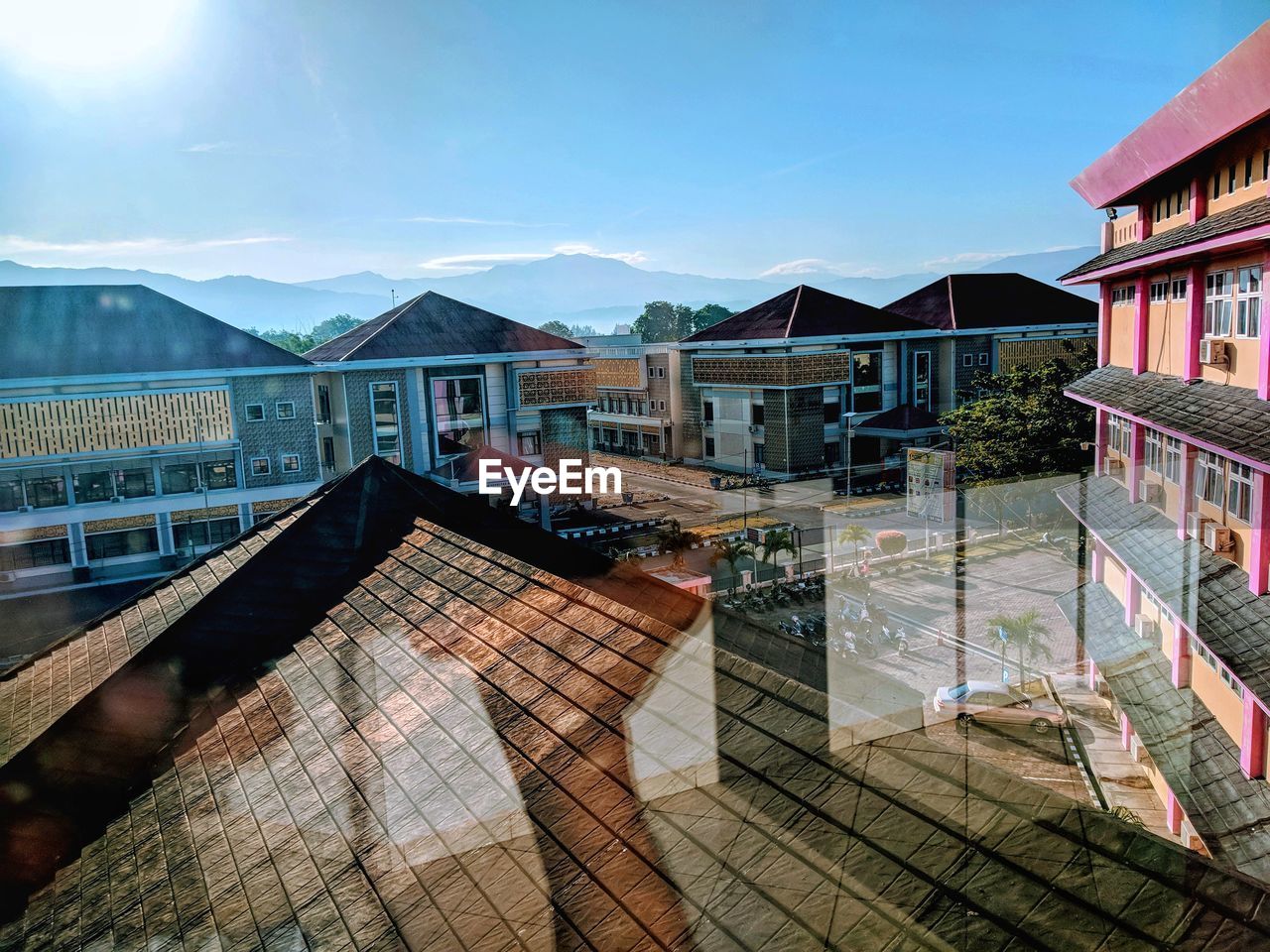 Buildings in city seen through glass window