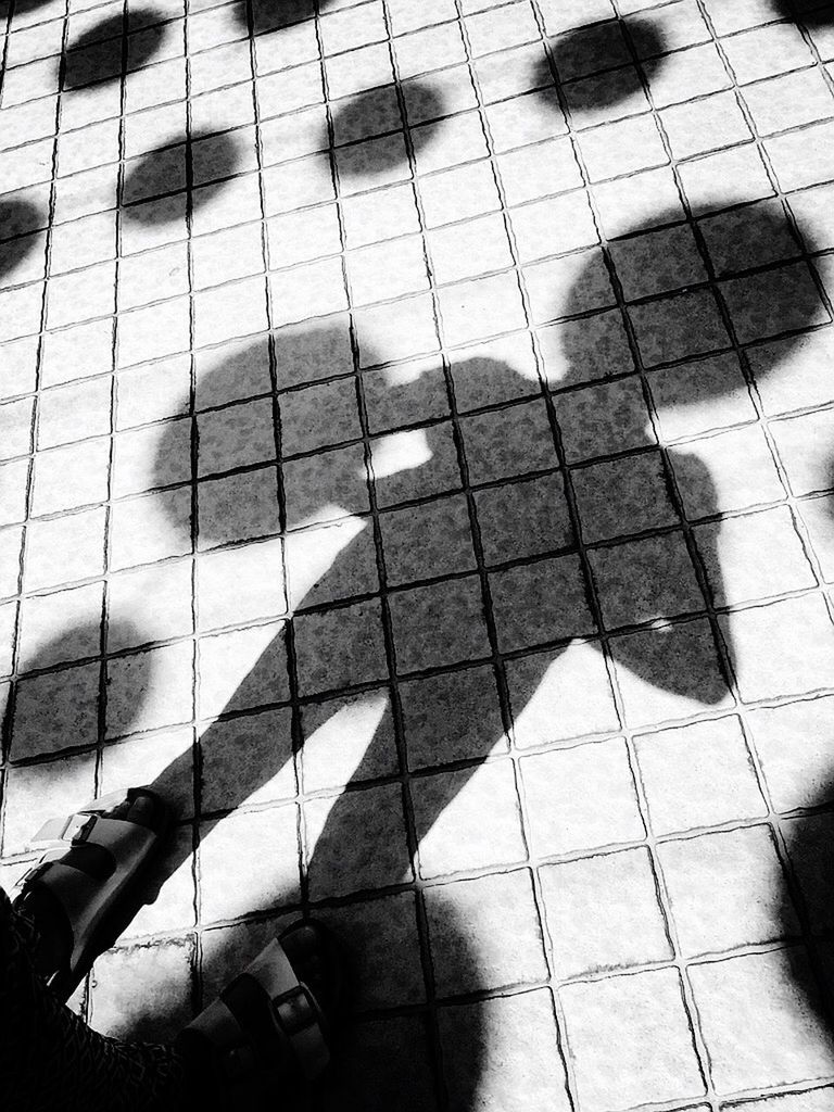 SHADOW OF PEOPLE ON TILED FLOOR