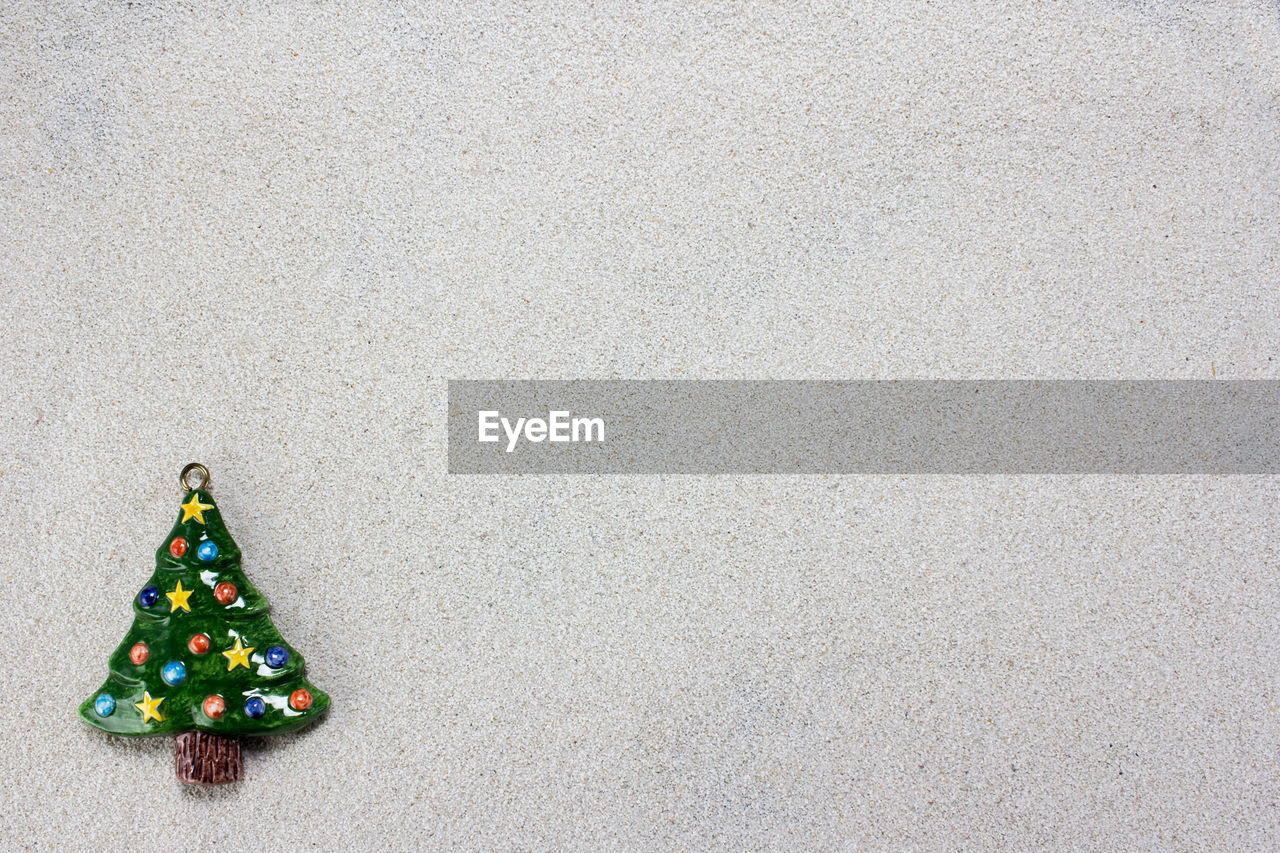 Close-up of artificial christmas tree on wall