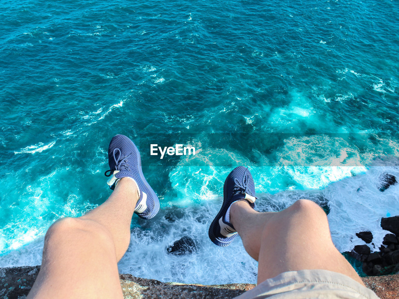 LOW SECTION OF MAN IN SWIMMING POOL